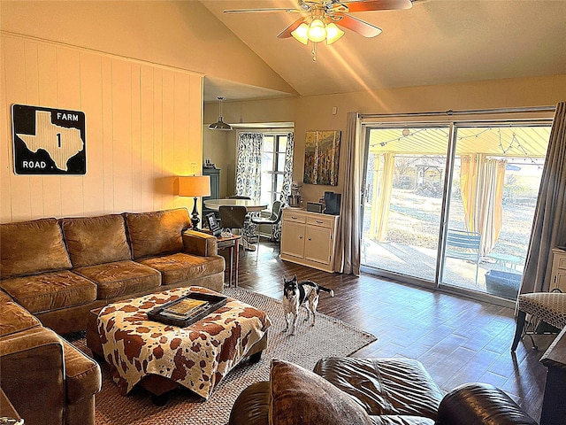 living room featuring ceiling fan, lofted ceiling, and dark hardwood / wood-style flooring