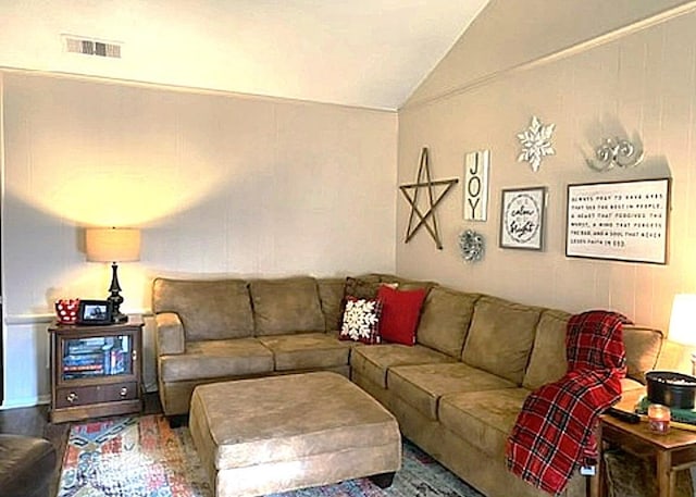 living room featuring lofted ceiling