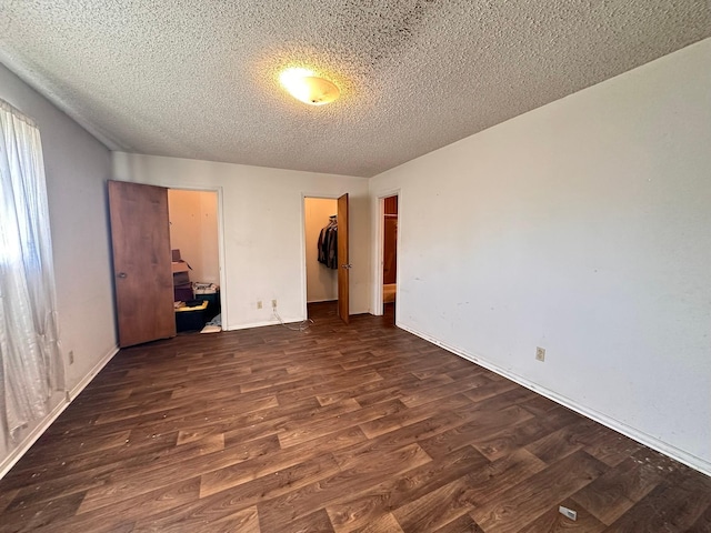 unfurnished bedroom with dark hardwood / wood-style flooring, a closet, and a textured ceiling