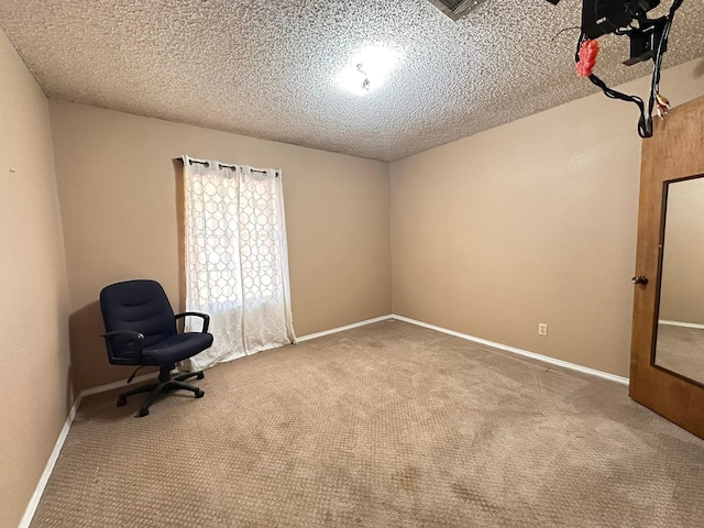 unfurnished room with a textured ceiling and carpet flooring