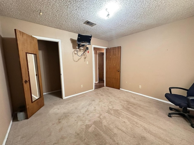 interior space with carpet floors and a textured ceiling