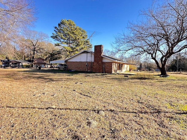 view of side of property with a yard