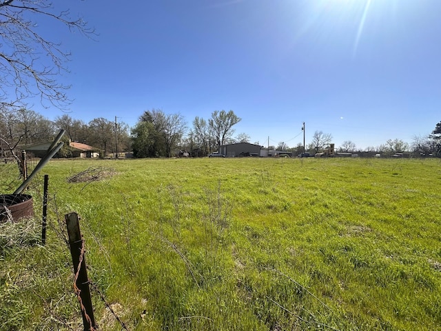 view of yard with a rural view