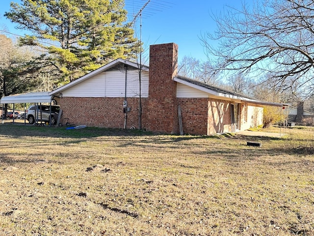 view of side of property with a yard and a carport