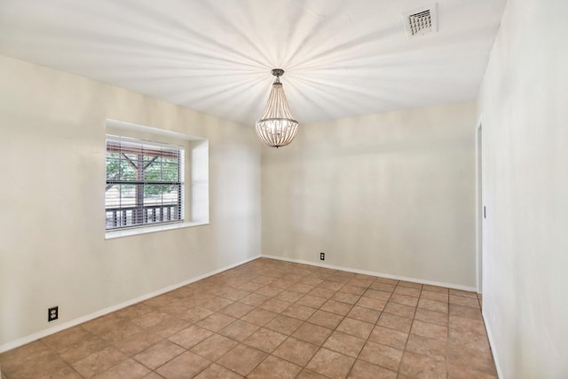 spare room featuring a notable chandelier