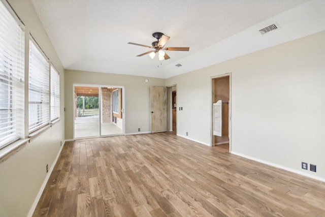 spare room with ceiling fan and light wood-type flooring