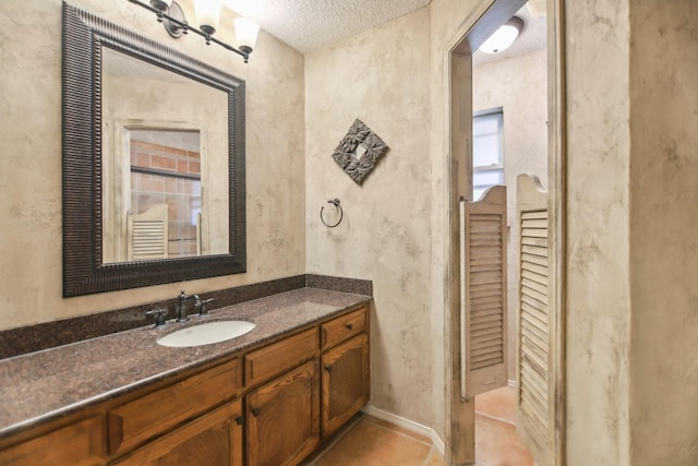 bathroom with vanity, tile patterned floors, and a textured ceiling