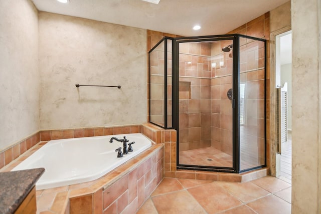 bathroom with independent shower and bath and tile patterned flooring