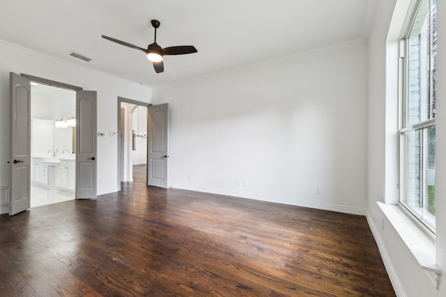 unfurnished bedroom with baseboards, crown molding, visible vents, and dark wood-style flooring