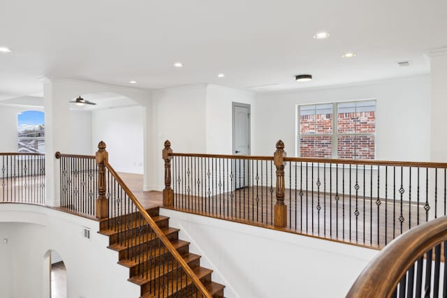 stairs featuring ornamental molding, recessed lighting, visible vents, and a ceiling fan