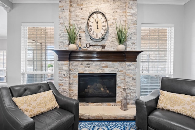 living room featuring crown molding and a fireplace