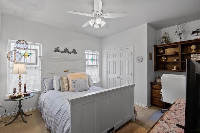 carpeted bedroom featuring ceiling fan and a closet