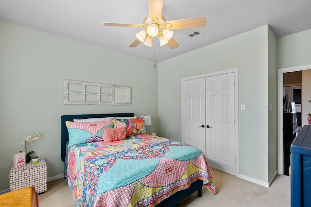 bedroom featuring ceiling fan, light colored carpet, and a closet