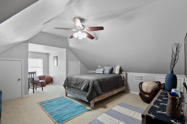 carpeted bedroom with ceiling fan and vaulted ceiling