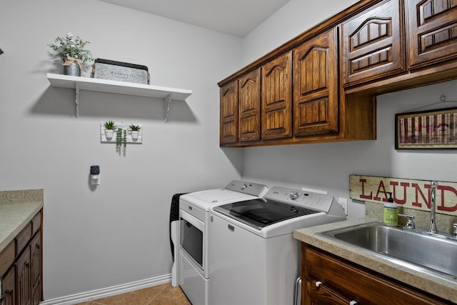 laundry room featuring cabinets, light tile patterned flooring, separate washer and dryer, and sink