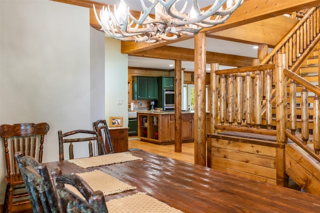 dining area featuring beamed ceiling and wood-type flooring