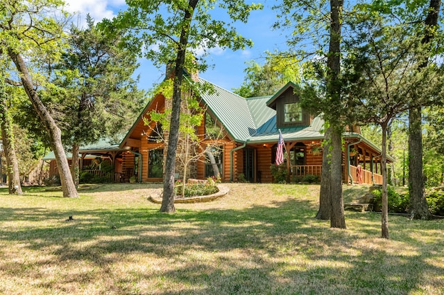 cabin featuring a front lawn