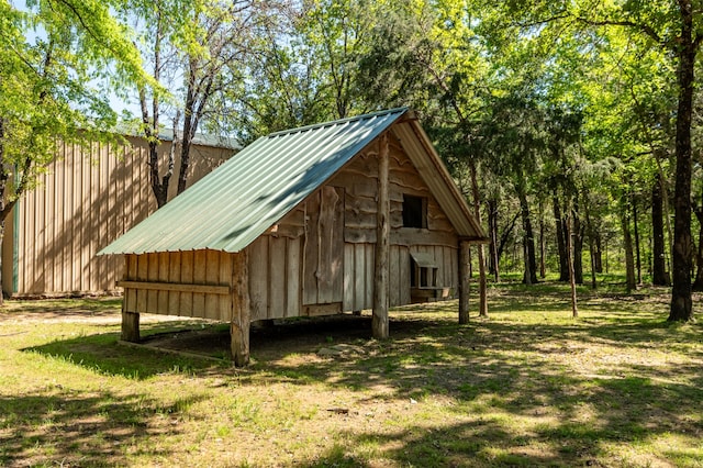 view of outbuilding featuring a yard