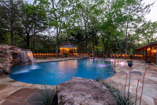 view of swimming pool featuring a water slide, an outbuilding, and a patio area