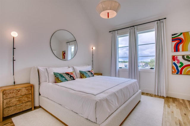 bedroom featuring hardwood / wood-style flooring and vaulted ceiling