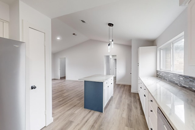 kitchen with white cabinetry, light stone counters, hanging light fixtures, and a kitchen island