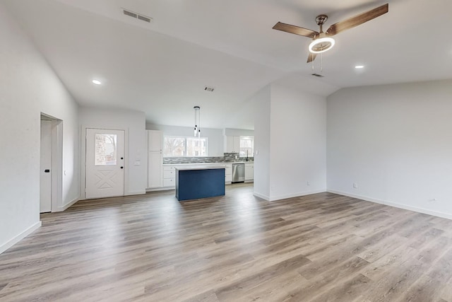 unfurnished living room with lofted ceiling, sink, light hardwood / wood-style floors, and ceiling fan