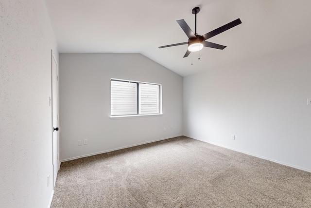 carpeted empty room with ceiling fan and lofted ceiling