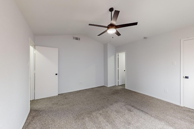 carpeted spare room featuring lofted ceiling and ceiling fan