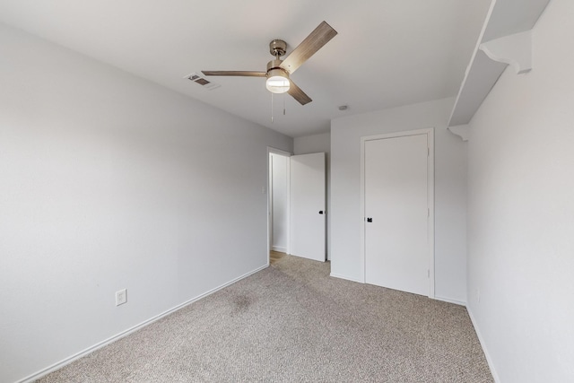 unfurnished bedroom with ceiling fan and light colored carpet