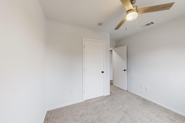 unfurnished bedroom with ceiling fan and light carpet