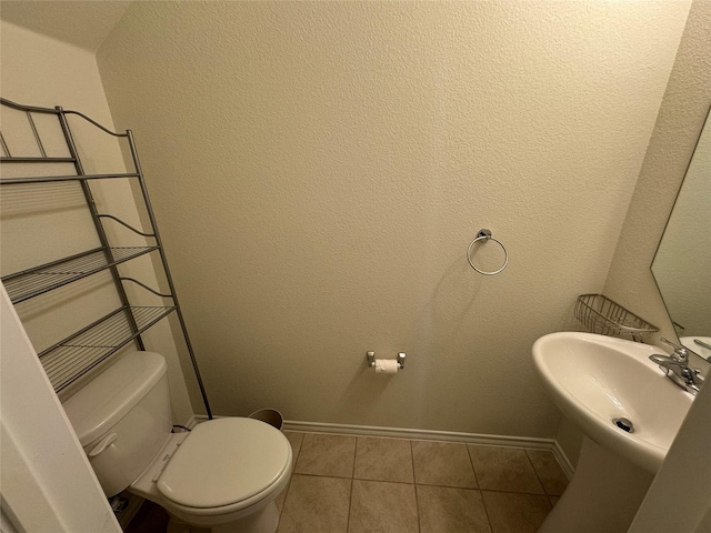 bathroom with sink, tile patterned floors, and toilet