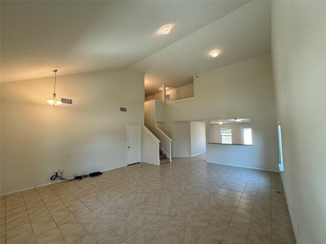 unfurnished living room featuring high vaulted ceiling