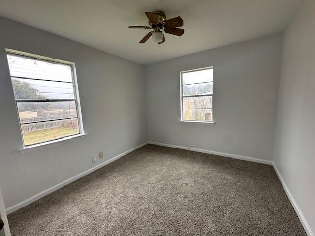 spare room with carpet floors and ceiling fan