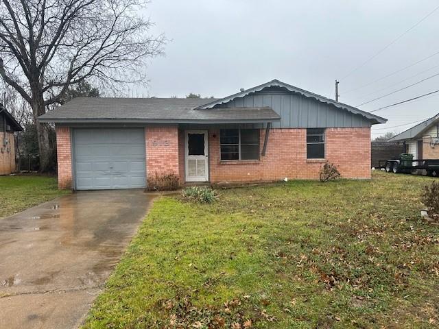 single story home featuring a garage and a front yard