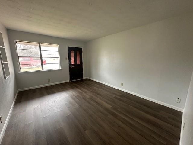 unfurnished room featuring dark hardwood / wood-style flooring