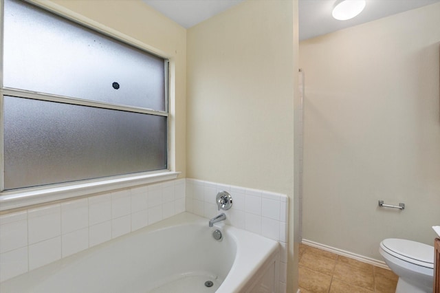 bathroom featuring vanity, tile patterned floors, toilet, and a bathing tub