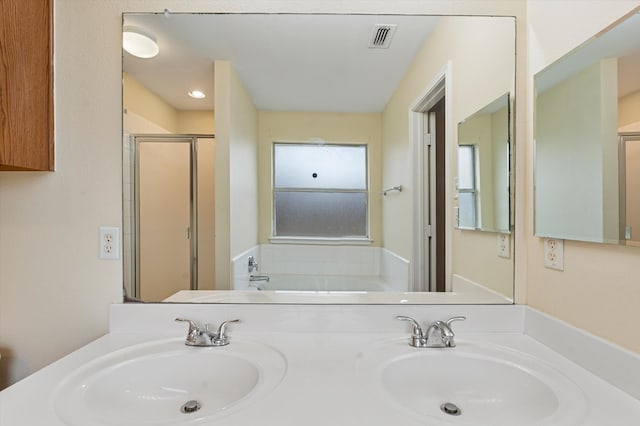 bathroom featuring shower with separate bathtub and vanity