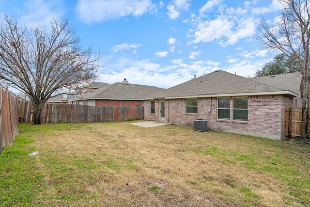 rear view of house featuring central AC unit, a patio, and a lawn