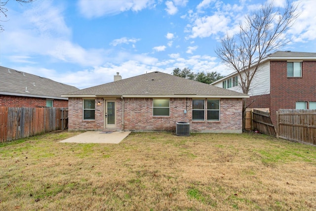 rear view of property featuring a yard and a patio area