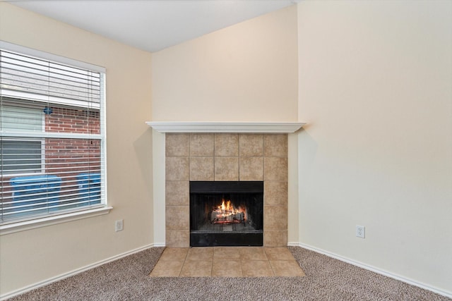 room details with a tiled fireplace and carpet floors