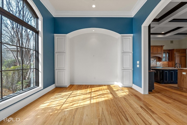 unfurnished room featuring beamed ceiling, crown molding, coffered ceiling, and light hardwood / wood-style flooring