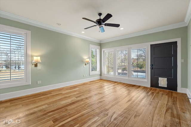 spare room featuring crown molding, ceiling fan, and light hardwood / wood-style floors