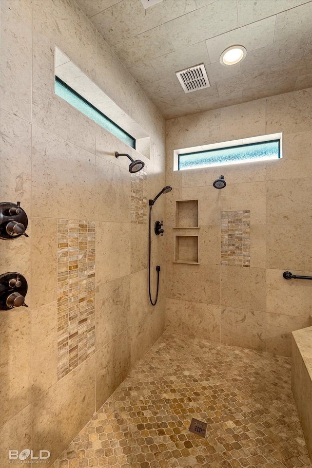 bathroom featuring a tile shower