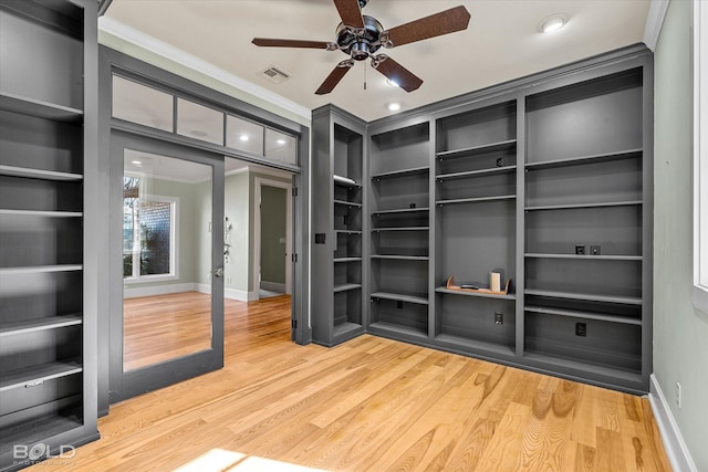 spacious closet with hardwood / wood-style flooring, french doors, and ceiling fan