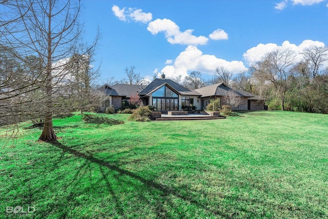 rear view of property featuring a yard