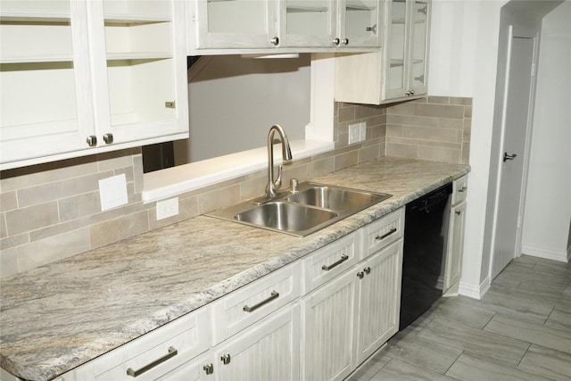 kitchen featuring white cabinetry, sink, and black dishwasher