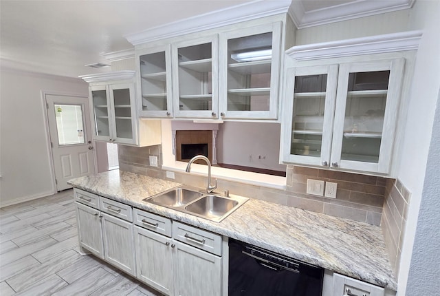 kitchen with tasteful backsplash, sink, white cabinets, and dishwasher