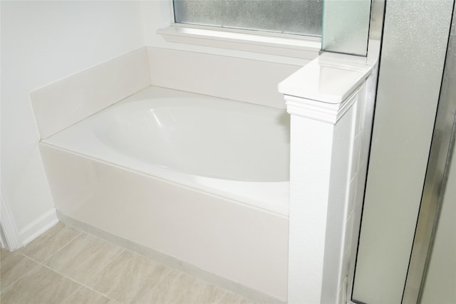 bathroom with tile patterned floors and a bathing tub