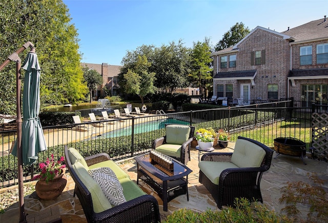 view of patio with fence, an outdoor hangout area, and a fenced in pool