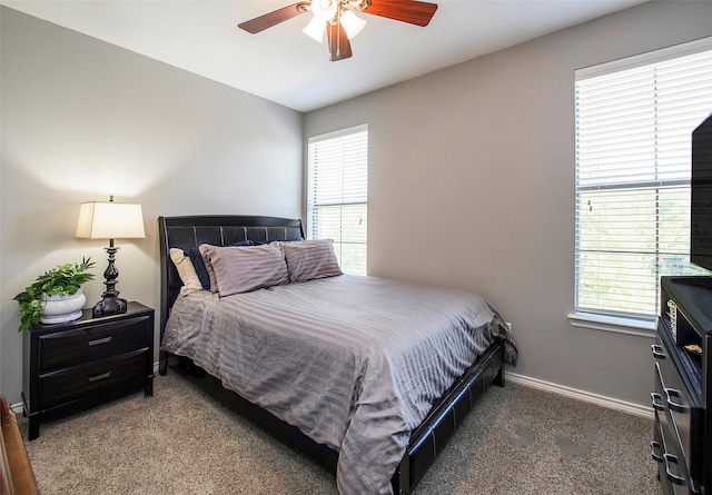 bedroom with ceiling fan, carpet, and multiple windows